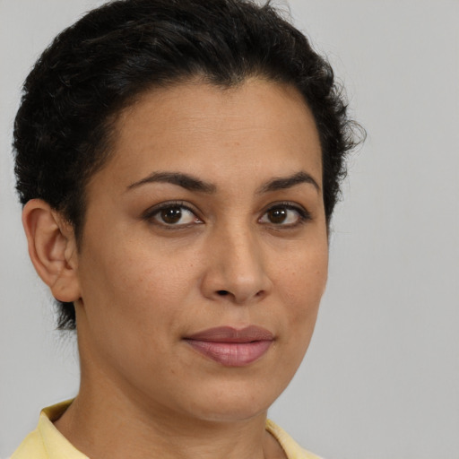 Joyful latino young-adult female with short  brown hair and brown eyes