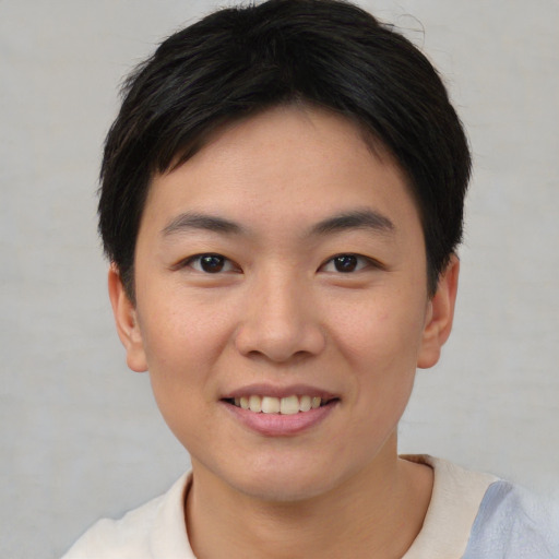 Joyful asian young-adult female with short  brown hair and brown eyes