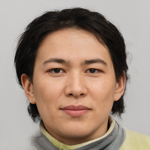Joyful asian adult female with medium  brown hair and brown eyes