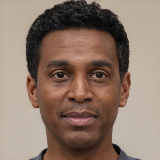 Neutral black young-adult male with short  black hair and brown eyes