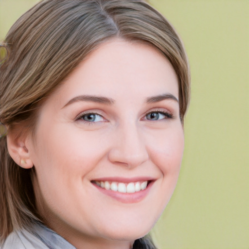 Joyful white young-adult female with long  brown hair and blue eyes