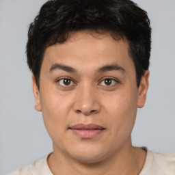 Joyful asian young-adult male with short  brown hair and brown eyes