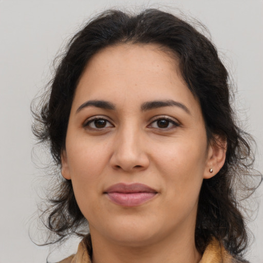 Joyful latino young-adult female with medium  brown hair and brown eyes