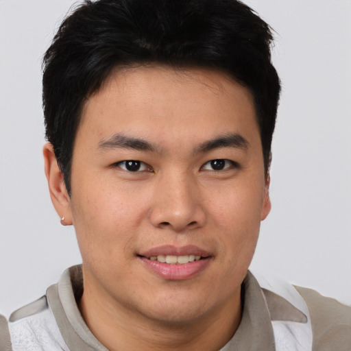 Joyful asian young-adult male with short  brown hair and brown eyes