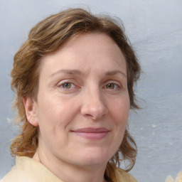 Joyful white adult female with medium  brown hair and blue eyes