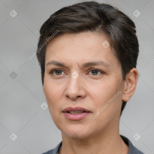 Joyful white adult female with short  brown hair and brown eyes