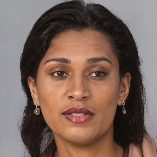 Neutral latino adult female with long  brown hair and brown eyes