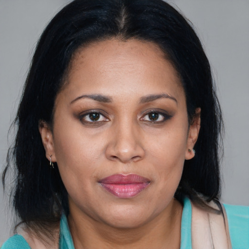 Joyful black adult female with medium  brown hair and brown eyes