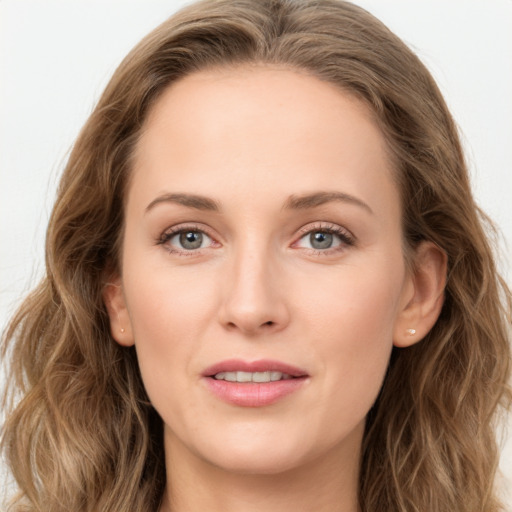 Joyful white young-adult female with long  brown hair and blue eyes