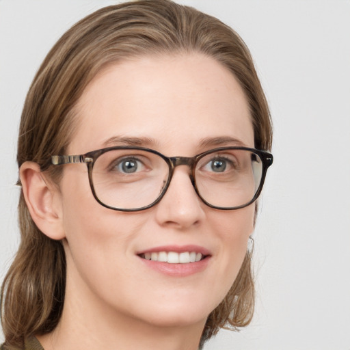 Joyful white young-adult female with medium  brown hair and blue eyes