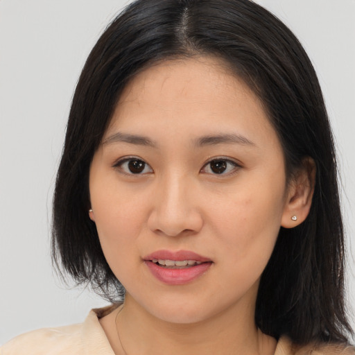 Joyful asian young-adult female with medium  brown hair and brown eyes