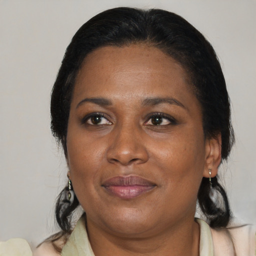 Joyful black adult female with medium  brown hair and brown eyes