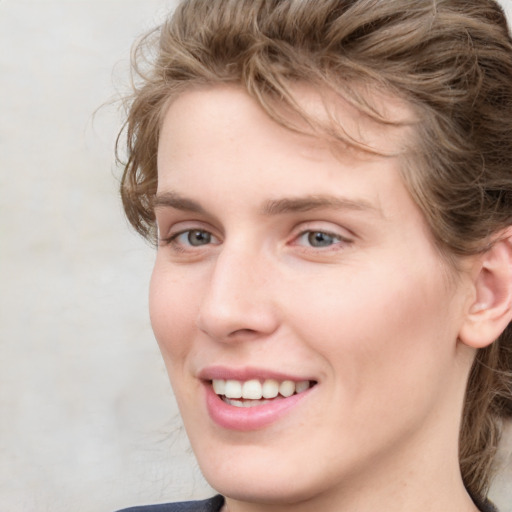 Joyful white young-adult female with medium  brown hair and blue eyes