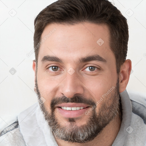 Joyful white young-adult male with short  brown hair and brown eyes