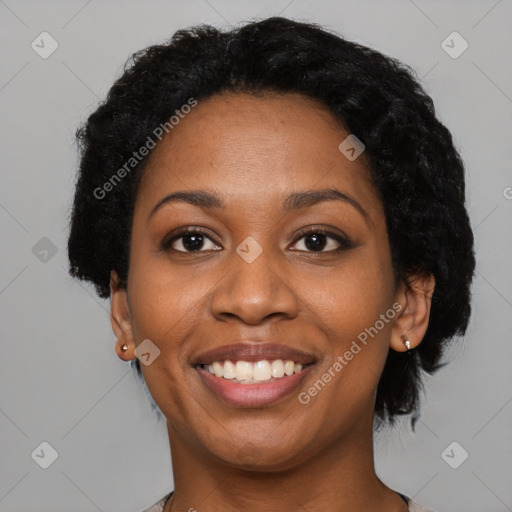 Joyful black adult female with short  black hair and brown eyes