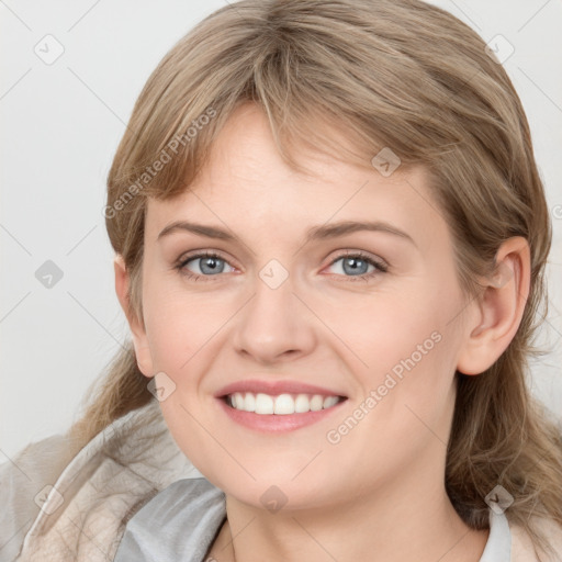 Joyful white young-adult female with medium  brown hair and blue eyes