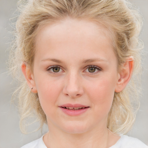 Joyful white young-adult female with medium  blond hair and blue eyes