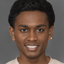 Joyful black young-adult male with short  brown hair and brown eyes