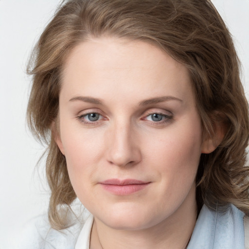 Joyful white young-adult female with medium  brown hair and blue eyes