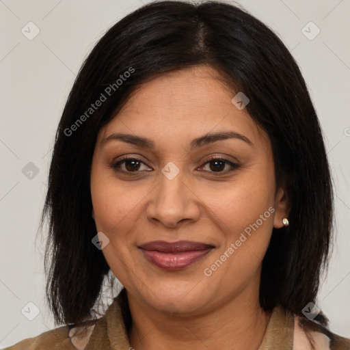 Joyful latino adult female with medium  brown hair and brown eyes