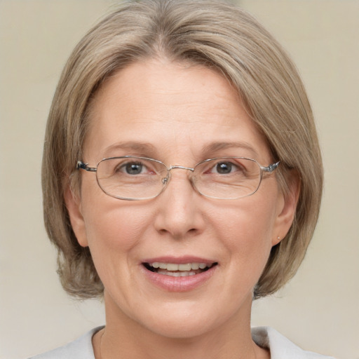 Joyful white middle-aged female with medium  brown hair and blue eyes