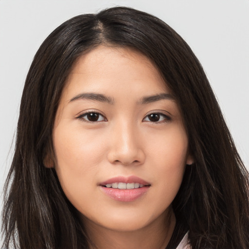 Joyful asian young-adult female with long  brown hair and brown eyes