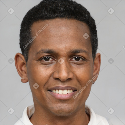 Joyful black adult male with short  black hair and brown eyes