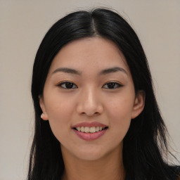 Joyful asian young-adult female with long  black hair and brown eyes