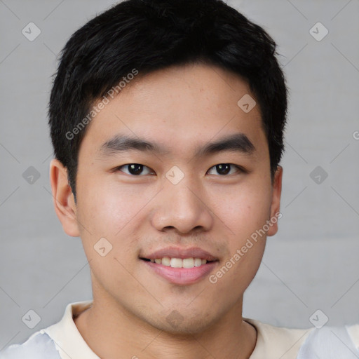 Joyful asian young-adult male with short  black hair and brown eyes