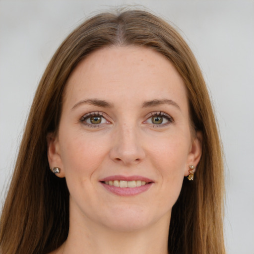 Joyful white young-adult female with long  brown hair and green eyes