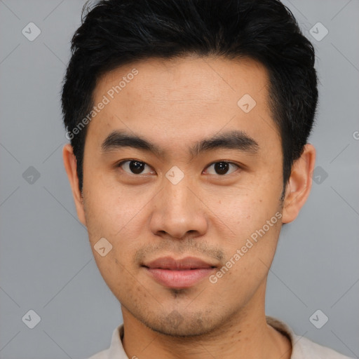 Joyful asian young-adult male with short  black hair and brown eyes