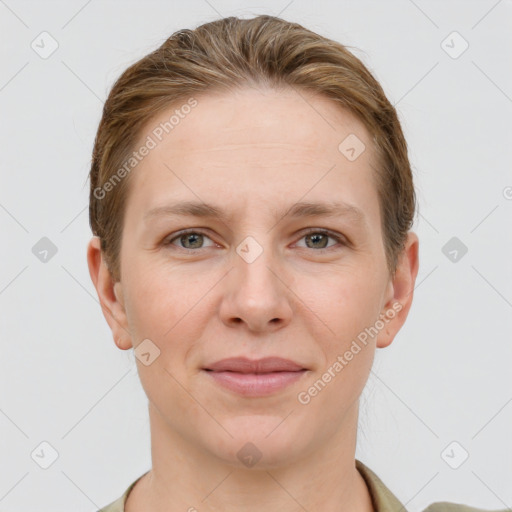 Joyful white young-adult female with short  brown hair and grey eyes