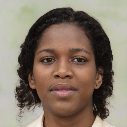 Neutral black young-adult female with medium  brown hair and brown eyes