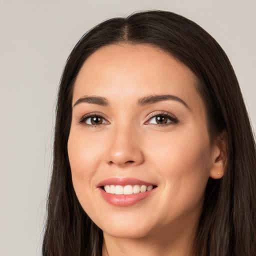 Joyful white young-adult female with long  black hair and brown eyes