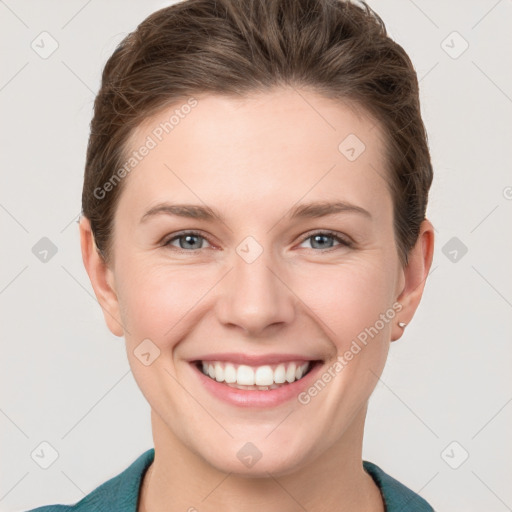 Joyful white young-adult female with short  brown hair and grey eyes