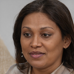 Joyful white adult female with long  brown hair and brown eyes