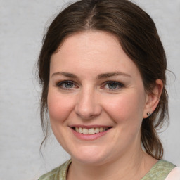 Joyful white young-adult female with medium  brown hair and grey eyes