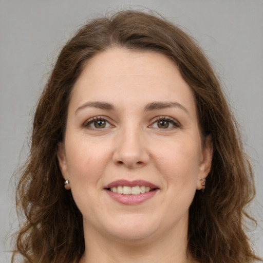 Joyful white adult female with long  brown hair and brown eyes