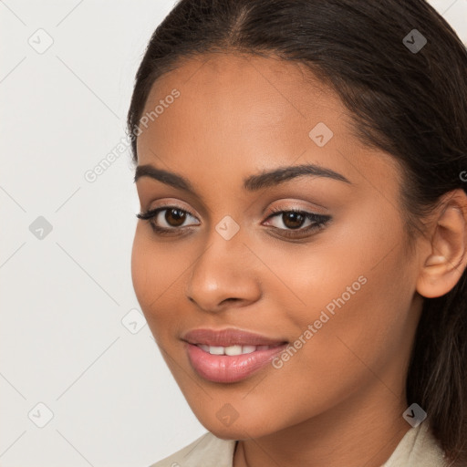 Joyful latino young-adult female with long  brown hair and brown eyes