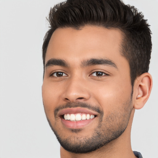 Joyful white young-adult male with short  black hair and brown eyes