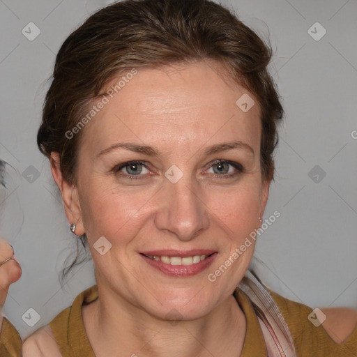 Joyful white adult female with medium  brown hair and blue eyes