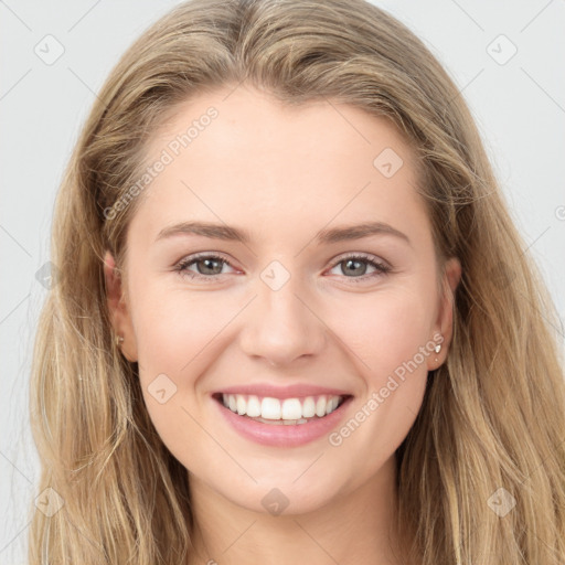 Joyful white young-adult female with long  brown hair and grey eyes