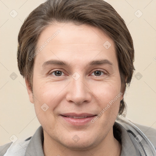 Joyful white adult male with short  brown hair and grey eyes