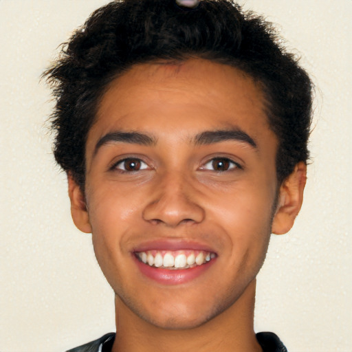 Joyful latino young-adult male with short  brown hair and brown eyes