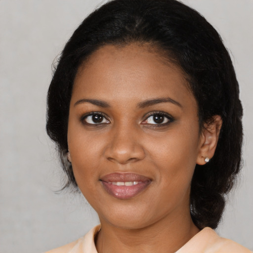 Joyful black young-adult female with medium  black hair and brown eyes