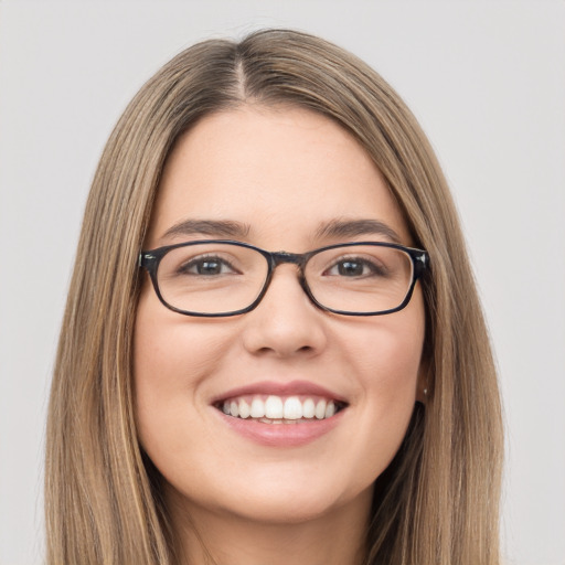 Joyful white young-adult female with long  brown hair and green eyes