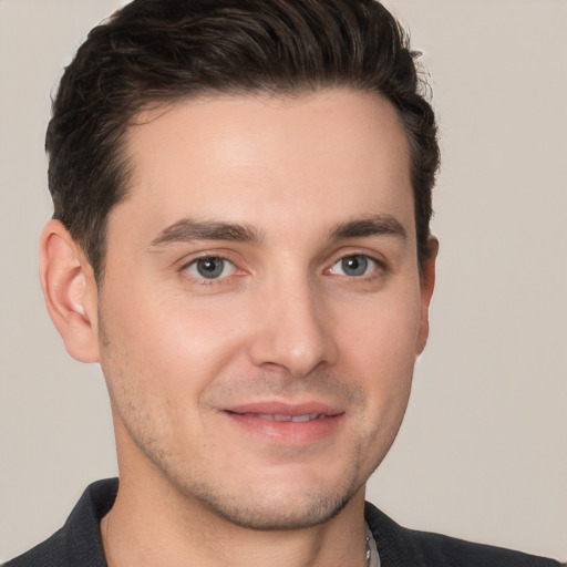 Joyful white young-adult male with short  brown hair and brown eyes