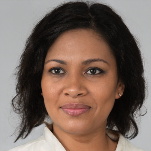 Joyful black young-adult female with medium  brown hair and brown eyes