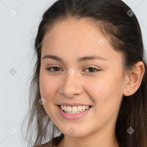 Joyful white young-adult female with long  brown hair and brown eyes