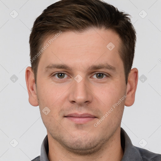 Joyful white young-adult male with short  brown hair and grey eyes